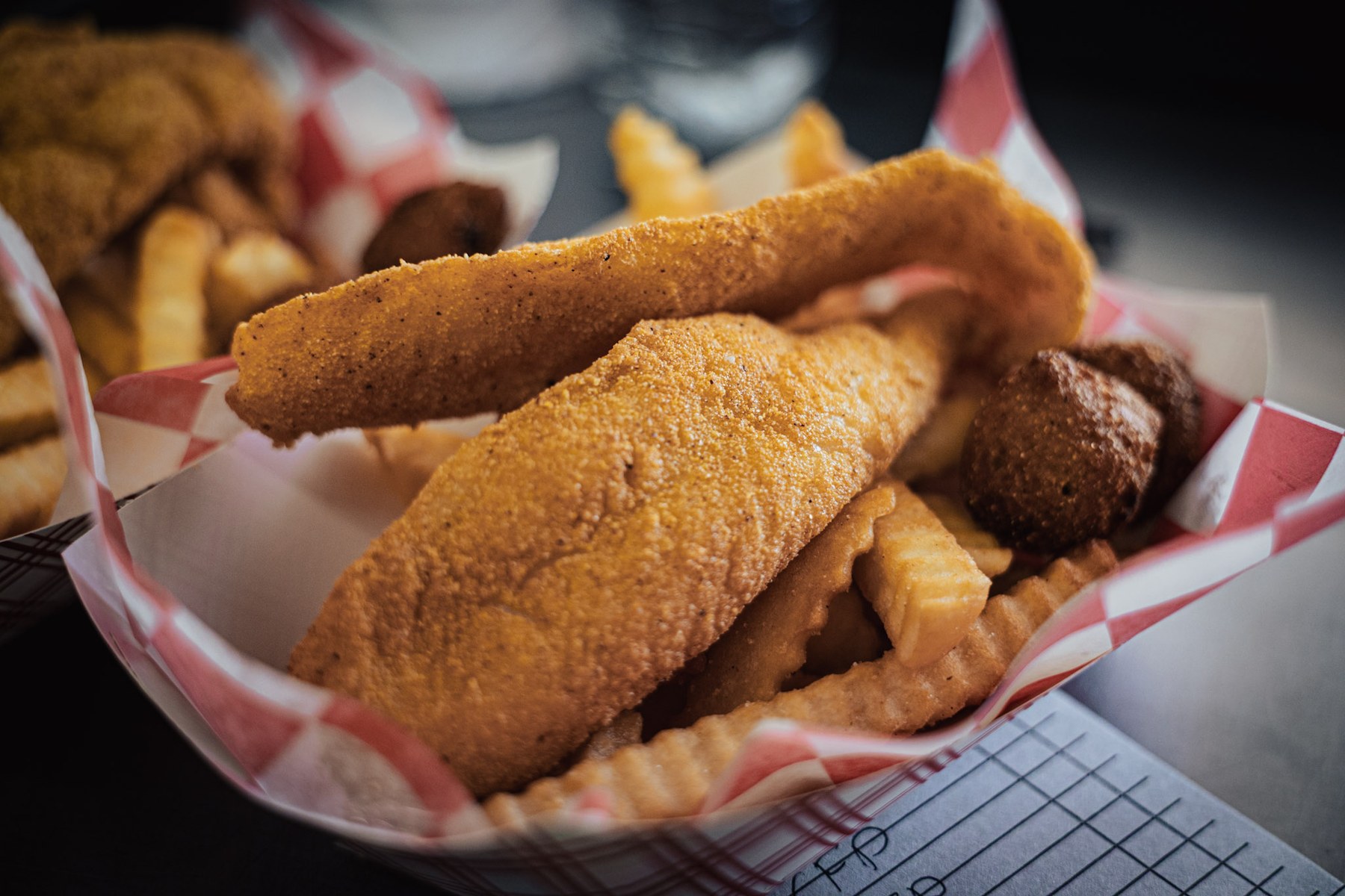 Fried catfish basket with hushpuppies and fries